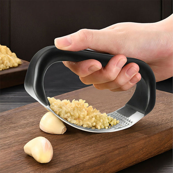 Sturdy garlic presser in multicolour for kitchen use. Sturdy garlic presser in multicolour for kitchen use.
